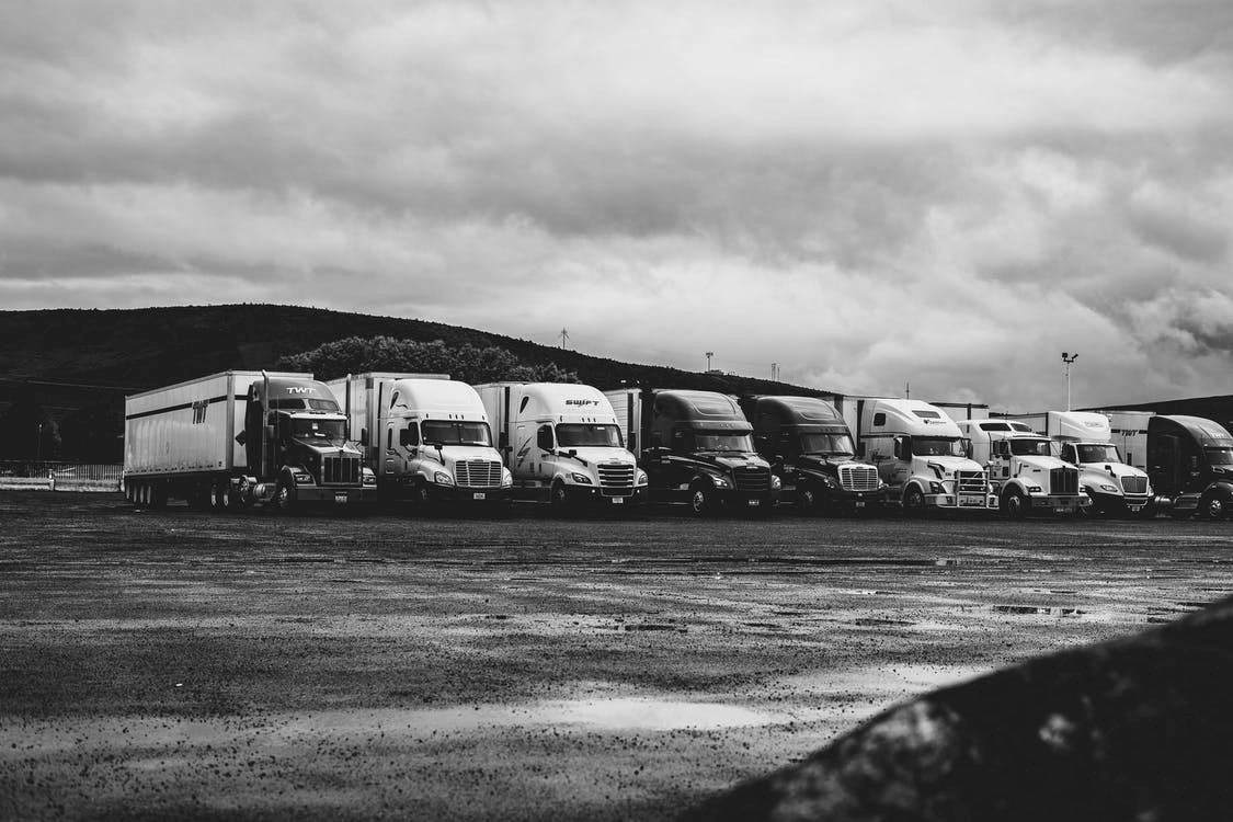 Black-and-white shot of Kenworth trucks on the lot