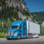 Scenic shot of truck with mountain background