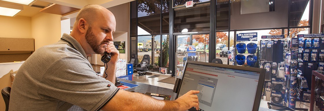 Kenworth employee on computer