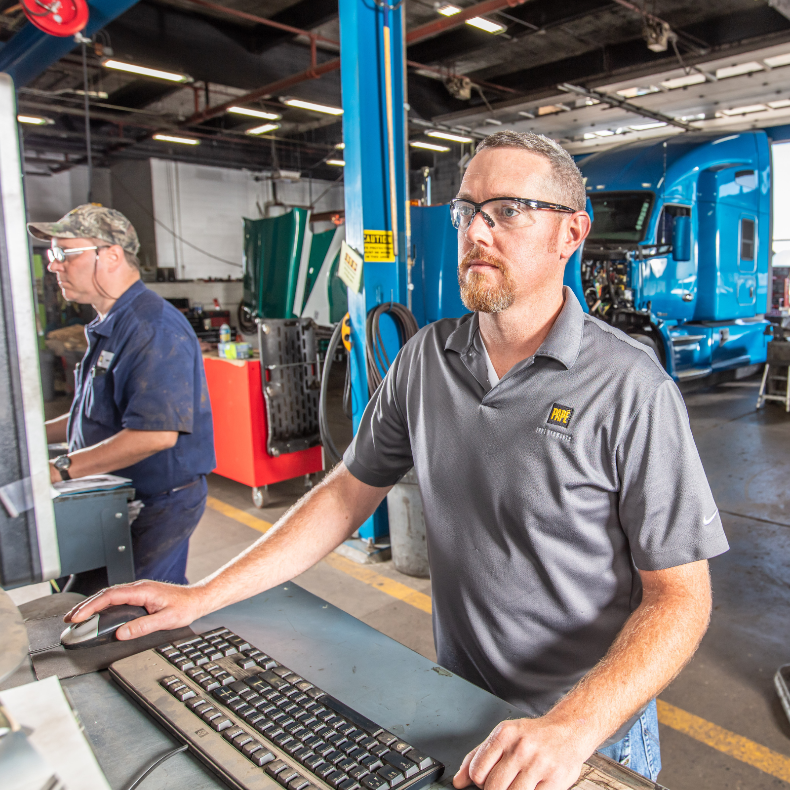Pape Kenworth member servicing a truck.