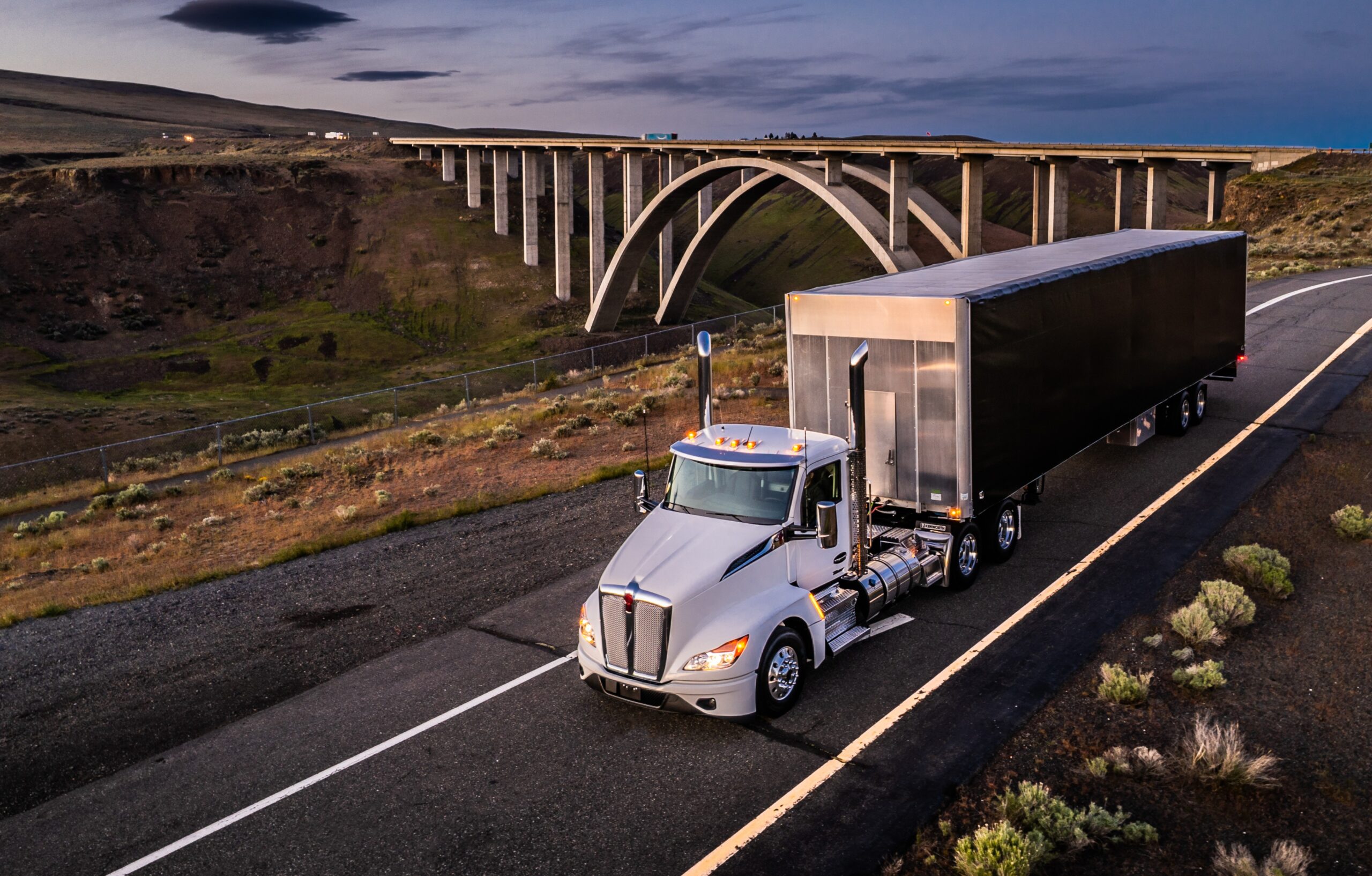 Kenworth T680 semi truck driving on the highway during Roadcheck season to support safe and compliant trucking operations
