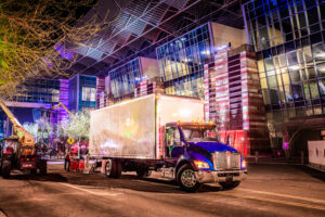 Kenworth box truck parked outside a commercial venue for urban delivery and event logistics operations