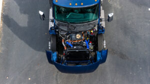 Top-down view of a Kenworth truck engine compartment during a routine maintenance and inspection.