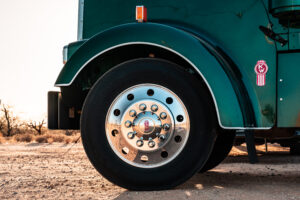 Close-up of a Kenworth truck tire and wheel assembly highlighting components inspected during routine maintenance.