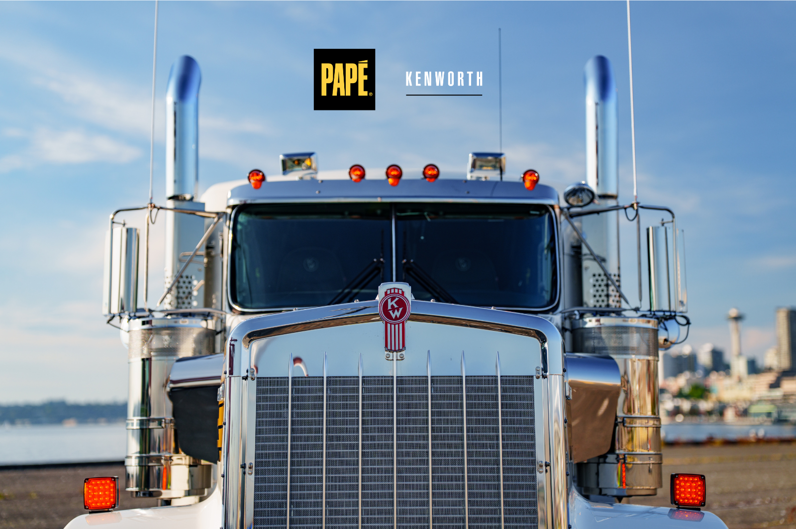 Lineup of Kenworth commercial trucks, including vocational and on-highway models, parked side by side.